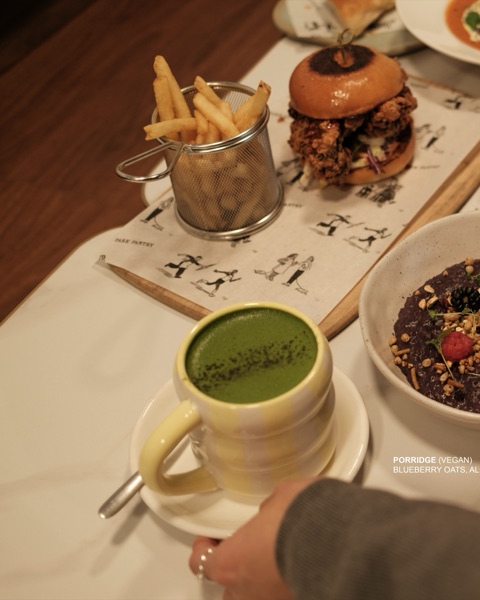 Matcha, porridge and burger on the table