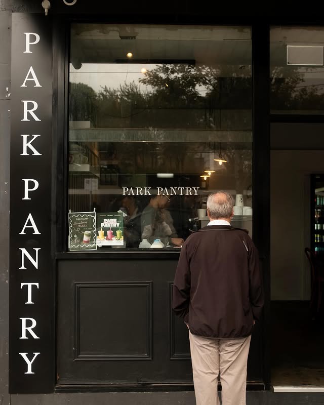 The black Park Pantry shopfront on Park Street, a guest reading the window menu