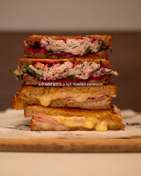 Toasties stacked on the board, over the words: a toasties is a hot, toasted sandwich